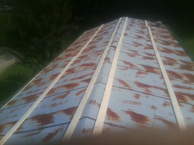 Rusted metal roof panels with new wood purlins before replacement — Storm Damage Roof Repair in Lawtey by Roofing Brothers